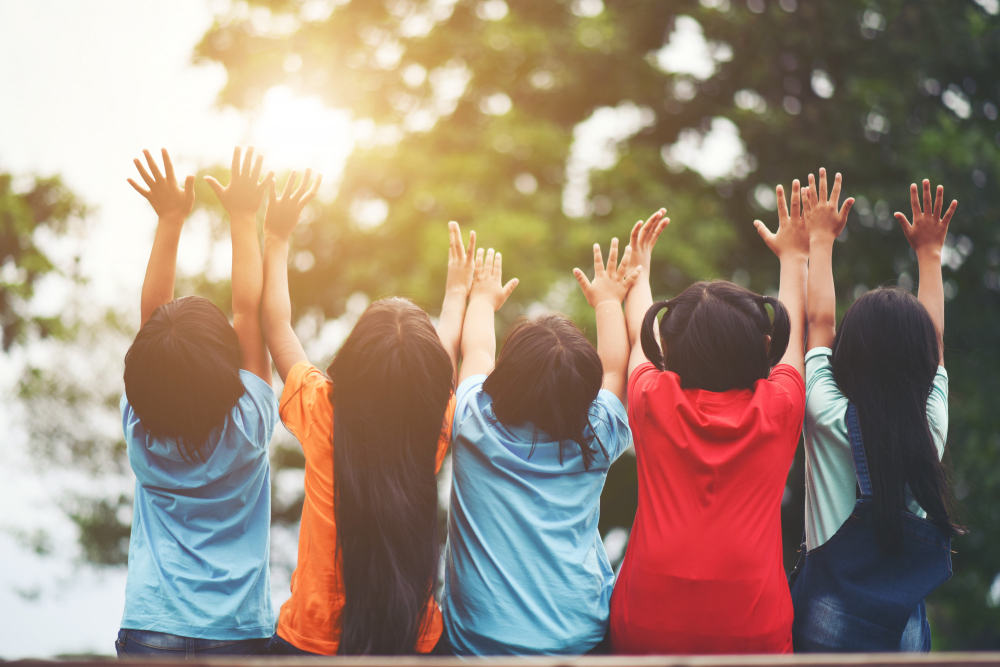 group-kids-friends-arm-around-sitting-together